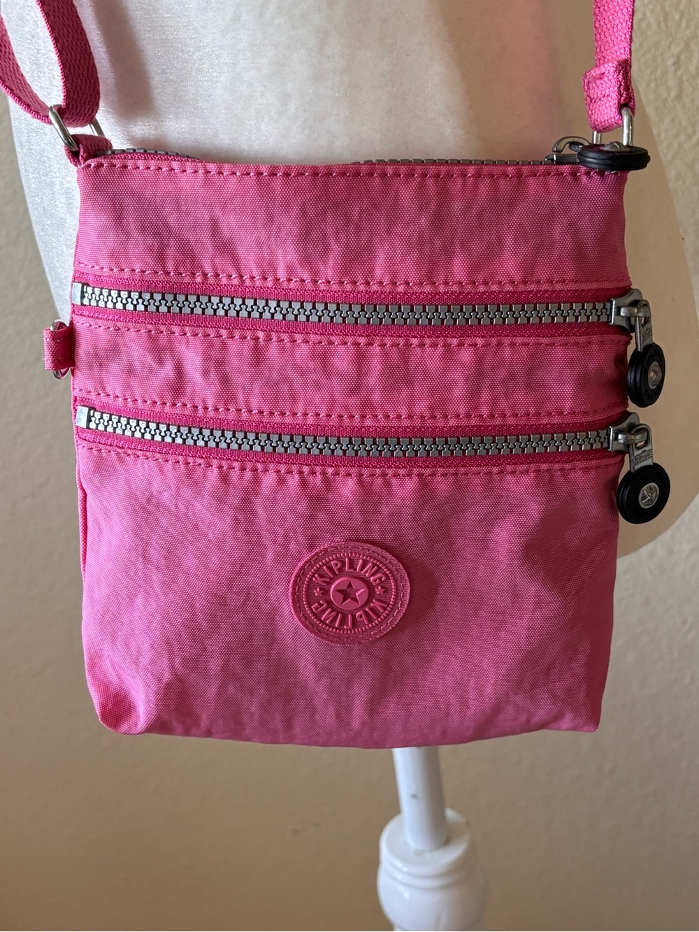 Kipling’s Alvar Pink Compact Crossbody Bag with Dual Zip Pockets